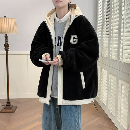 Model wearing a black hooded jacket with cream edging