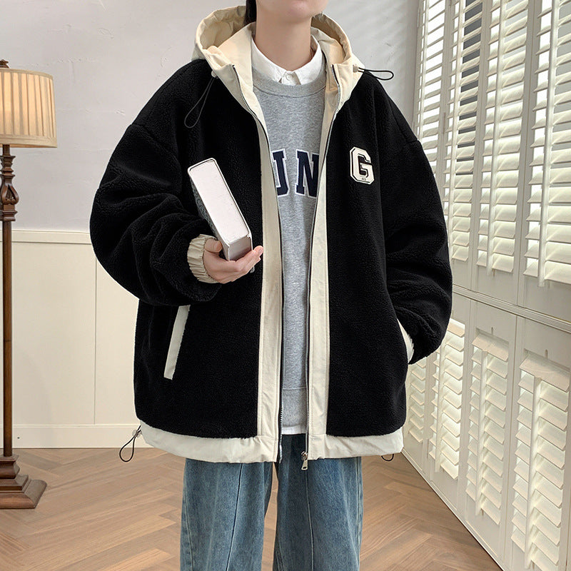 Model wearing a black zip jacket with cream edging